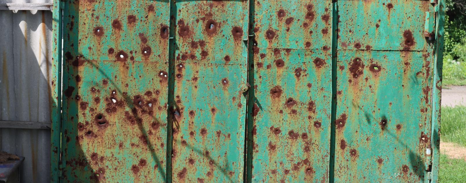 Gate of a house damaged during shelling in Mariinka, Donetsk region